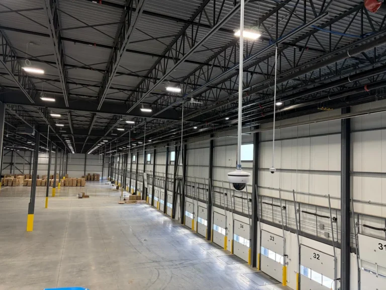 Long warehouse hall with high ceiling and cameras